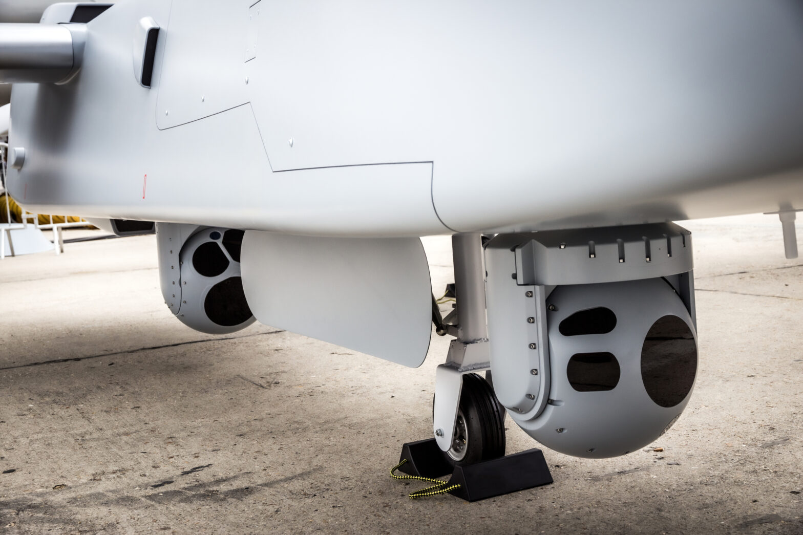 Camera sensor pods under an unmanned aerial surveillance drone aircraft.