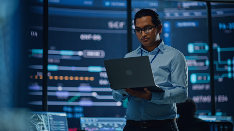 An engineer holds a laptop computer