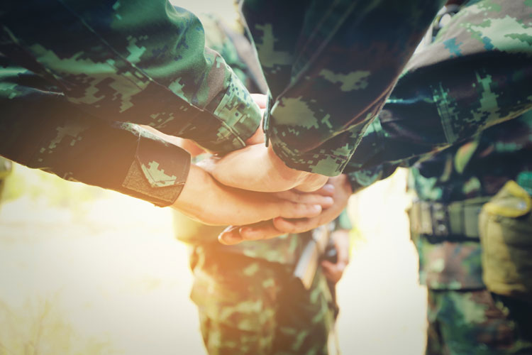 Teamwork Concept : Group of Soldier Hands Together Cross Processing ready to fight.